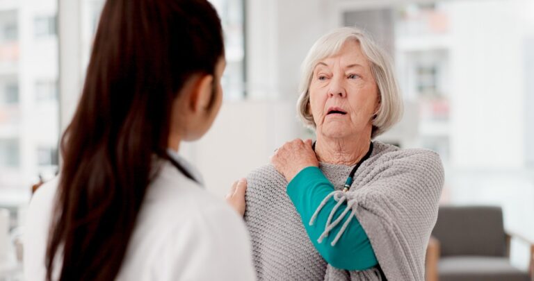 Healthcare shoulder pain woman with her doctor hospital talking consultation medical insurance anatomy senior female patient clinic with medicine professional