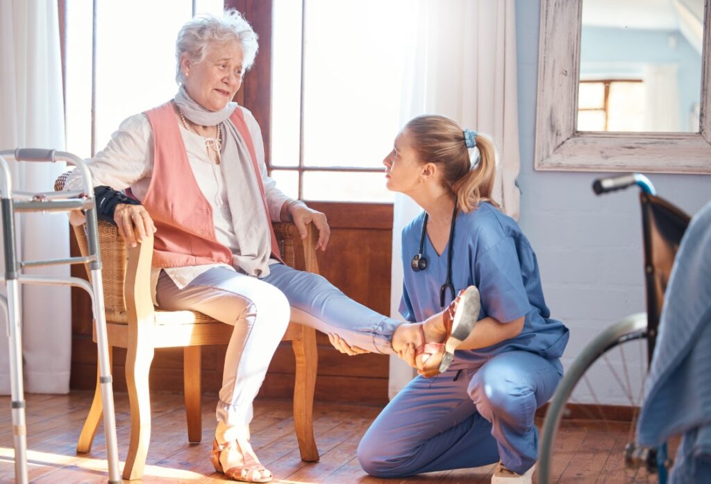 Senior woman rehabilitation help foot injury disability pain nursing home physiotherapist doctor treatment feet ankle legs with physical therapy elderly care nurse